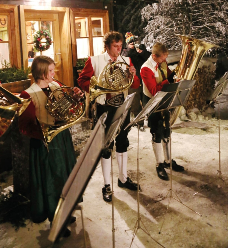 Bläser musizieren im Schnee in Walsertracht