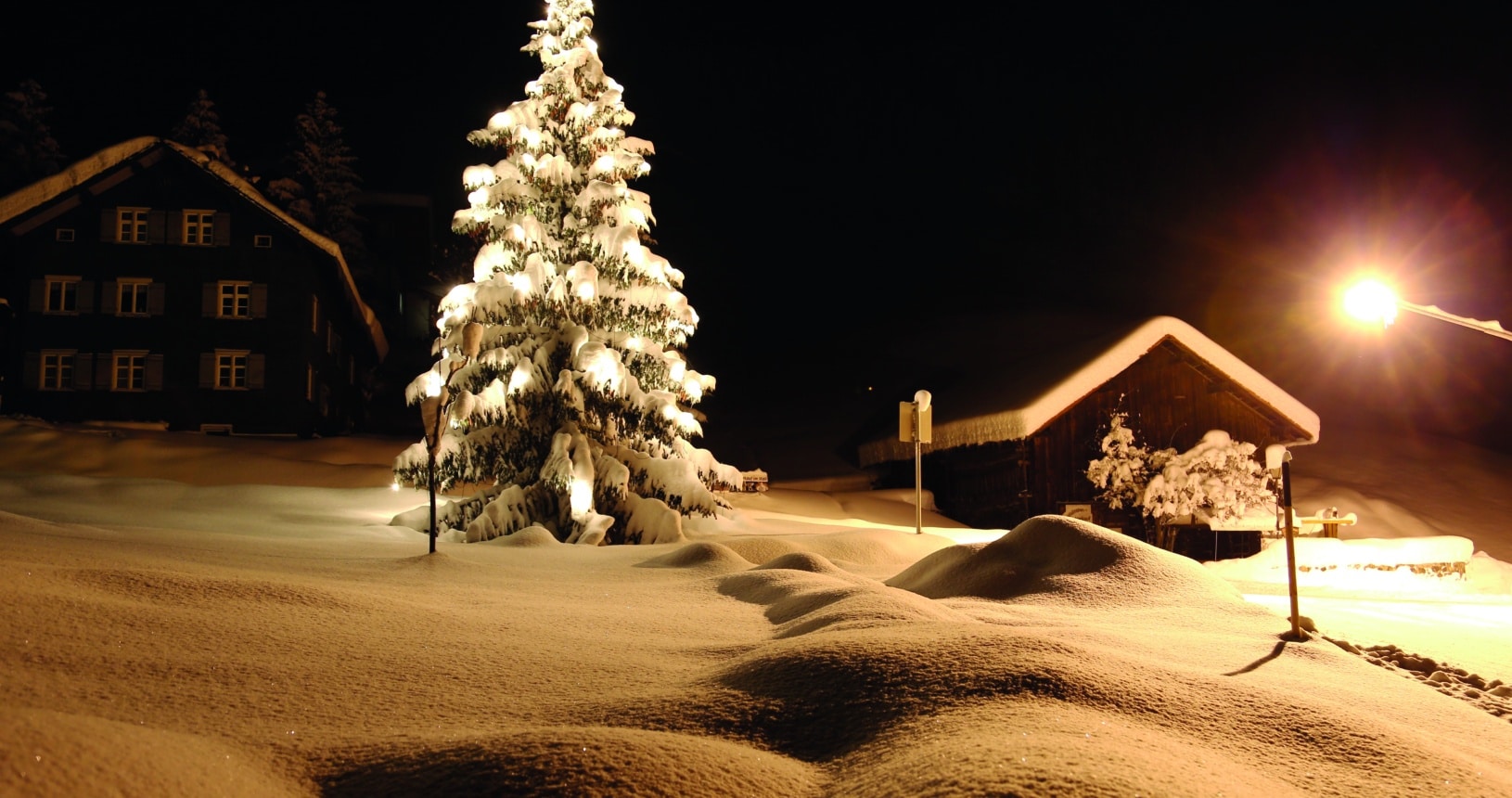 Winterlandschaft mit beleuchtetem Baum